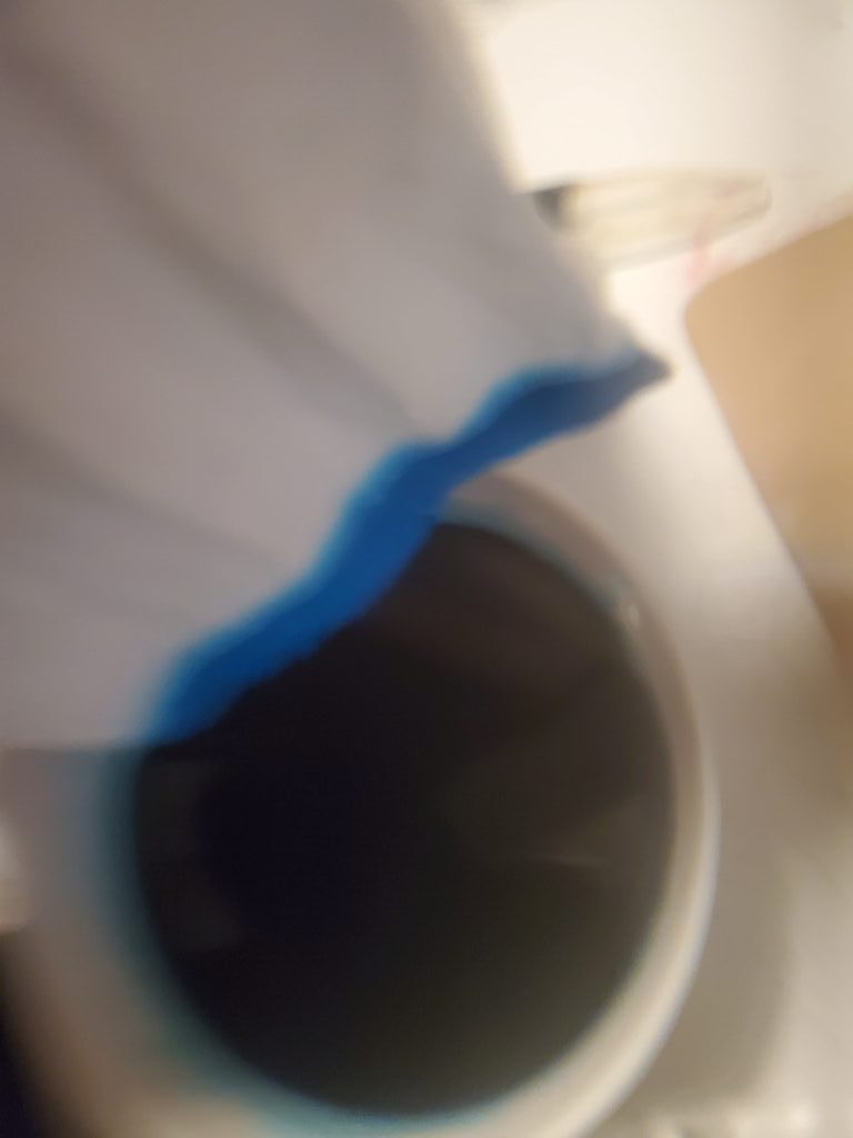 Dip edge of sleeve into blue dye